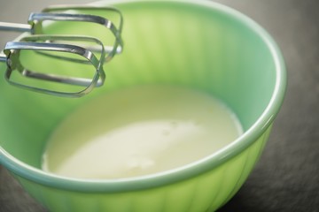 Close up of electric mixer by bowl with batter