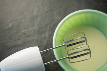 Overhead view of electric mixer by bowl with batter - Powered by Adobe
