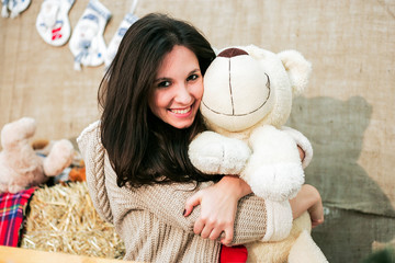 A cute girl holds a toy in her hand
