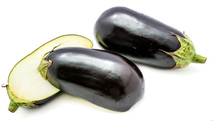 One whole and two halves eggplant (aubergine), longitudinal section, isolated on white background