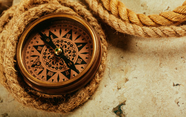 old-fashioned compass on rustic wooden table