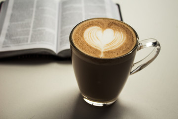open bible and a cup of cappuccino