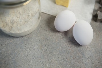 High angle view of eggs by flour in glass jar
