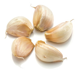 Separated garlic cloves folded in flower isolated on white background
