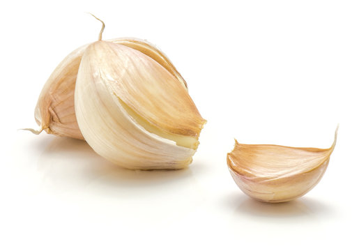 Three garlic cloves isolated on white background