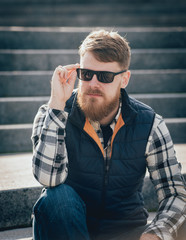 Handsome bearded man in casual clothes posing on camera