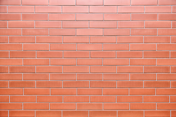 Wall with ceramic tiles in the form of brick.