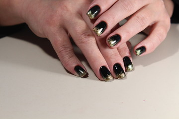Evening manicure design in black and gold color