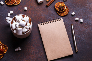 Christmas cookies in a white wooden box with hot chocolate and marshmelow, on a dark background, hands