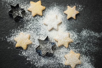Overhead view of star shape cookies with pastry cutter