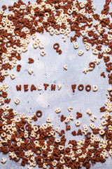 Dry breakfast, granola, muesli on a gray background, vertically, top view, copyspace, flat lay