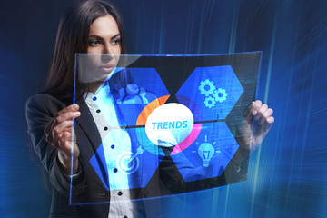 The concept of business, technology, the Internet and the network. A young entrepreneur working on a virtual screen of the future and sees the inscription: Trends