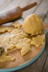 Dough on cutting board with star shape cutter