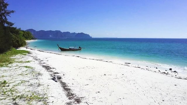 Long-tail boat on a beautiful beach at island in Krabi Thailand