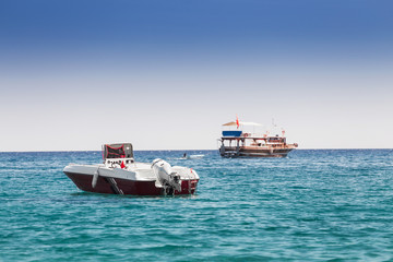 Fototapeta premium a motor boat stands in a sea bay, the concept of passenger transport in the beach resort