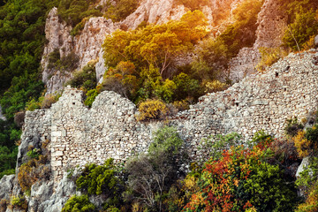 On the rock above the sea rise the ruined walls of the old city of Olympos in Lycia. Nowadays Turkey, Chirali