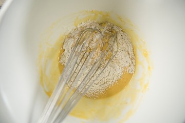 Close up of flour and egg batter in bowl