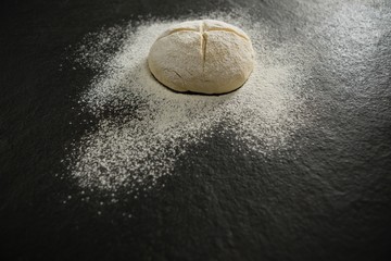 High angle view of flour on unbaked bun