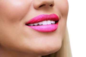 Fototapeta premium Sexy, Beauty pink Lips, Makeup Detail. Closeup. lipstick or Lipgloss. Blonde woman smiling on white isolate background. Clean white teeth. Medicine, healthy lifestyle, beauty care concept