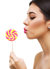 Close up of beautiful sexy woman model with pink lips and lollipop on white isolate background, profile. brunette girl with professional makeup