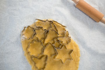 Overhead view of various shape pastry cutter on rolled dough
