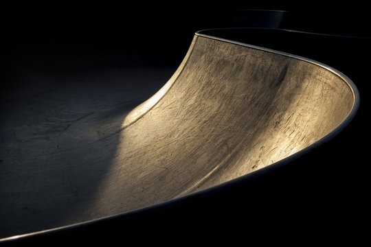 transitions of a skatepark bowl at sunrise
