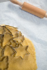 Close up of various shape pastry cutter on rolled dough