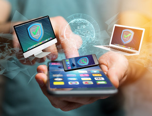 Security shield symbol over a network connection of different devices - Technology concept