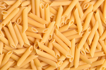 A lot of pasta. Dry pasta. Broken macaroni. Pasta. Pasta. Macaroni background. Food background.