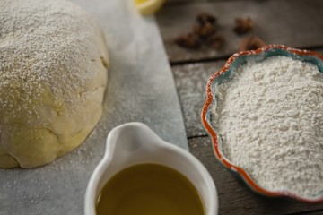 High angle view of dough and flour with cooking oil