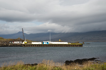 Hofn Harbor, Typical Icelandic landscape, a wild nature of rocks and shrubs, rivers and lakes.
