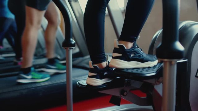 The girl with long hair walking, running on treadmill gym workout 4 k
