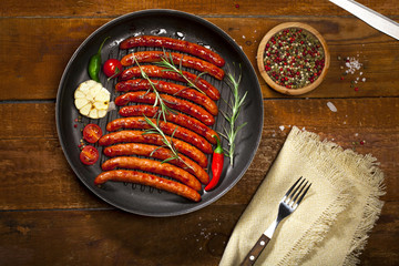 Wiener Sausages in a pan on wooden background