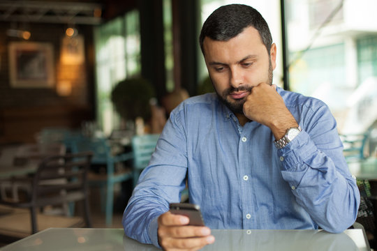 Handsome Man Texting On Phone