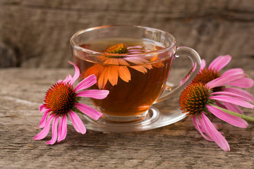 Cup of echinacea tea on old wooden table