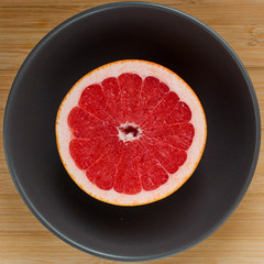 Grapefruit cut in a half in a plate 