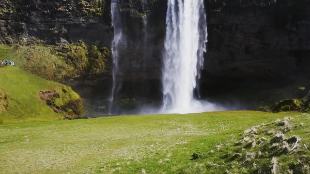 Woman taking picture of Seljalandsfoss watfall in Iceland