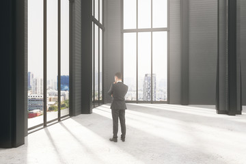 Fototapeta premium Pondering businessman in room