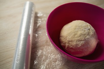 High angle view of kneaded dough in pink bowl