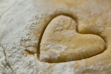 Fototapeta na wymiar Close up of heart shape on dough