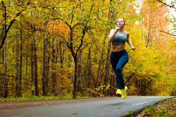Woman running in the autumn park