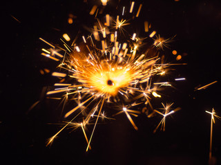 The bright stream of a sparks on the black background