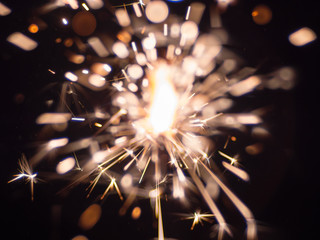 The bright stream of a sparks on the dark background