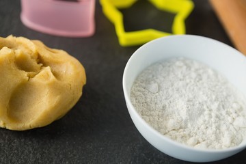High angle view of dough and flour in bowl
