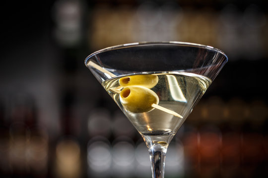 Martini cocktail with green olives