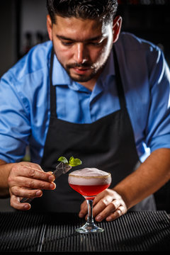 Bartender is decorating cocktail