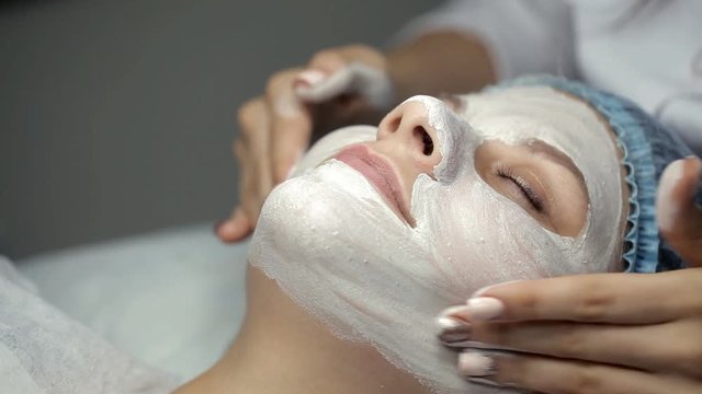 The cosmetologist does face massage to the client in excess of the mask