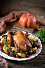 Grilled chicken on Thanksgiving day with corn, plum, dogwood and parsley.