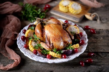 Grilled chicken on Thanksgiving day with corn, plum, dogwood and parsley.