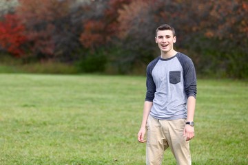 Portrait of a teenage boy laughing outdoors